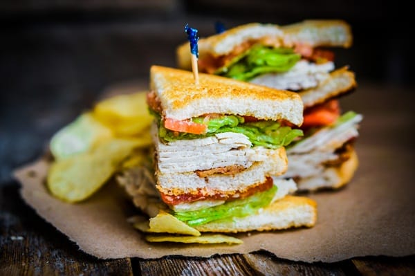 Club sandwich on rustic wooden background