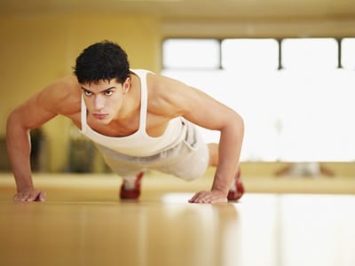 Man doing push-ups in a fitness studio