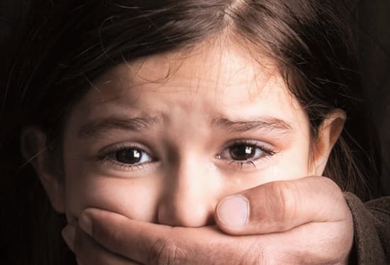 female-child-with-hand-over-her-mouth